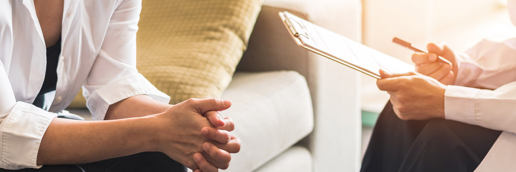 Two seated people facing each other as if talking