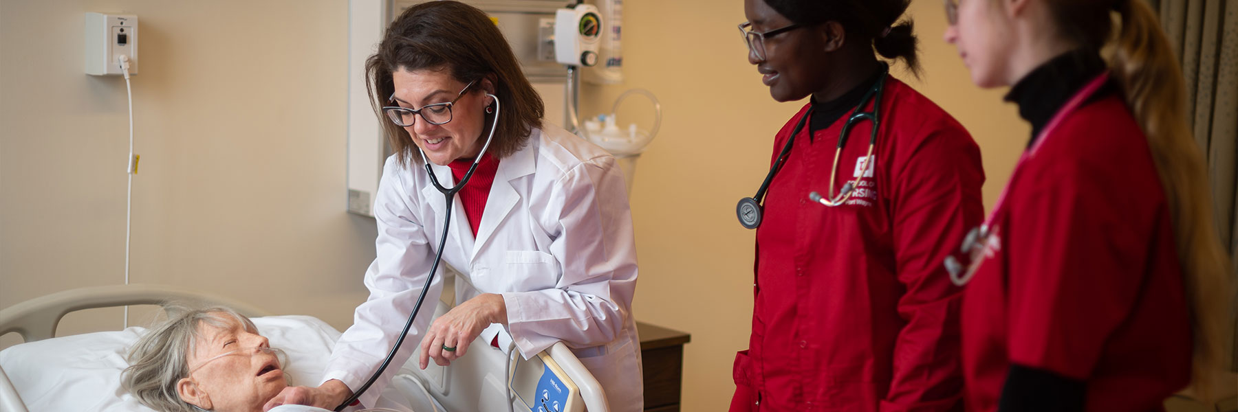 Nursing students learning from a faculty member