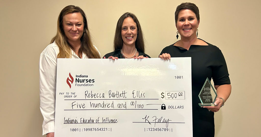 Indiana Nurses Foundation President Elizabeth Harris, Dr. Rebecca Bartlett Ellis, and Indiana State Nurses Association CEO Katie Feley pose for a photo