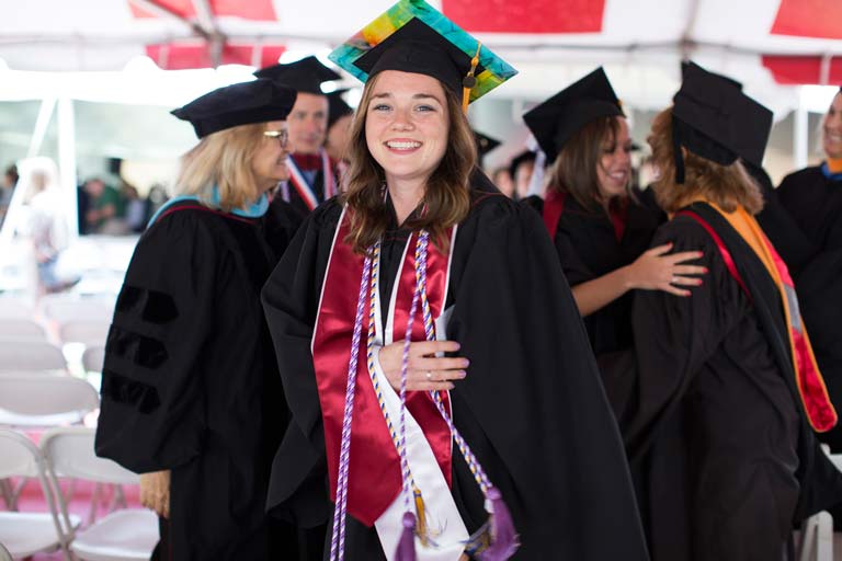 Smiling graduate in cap and gown