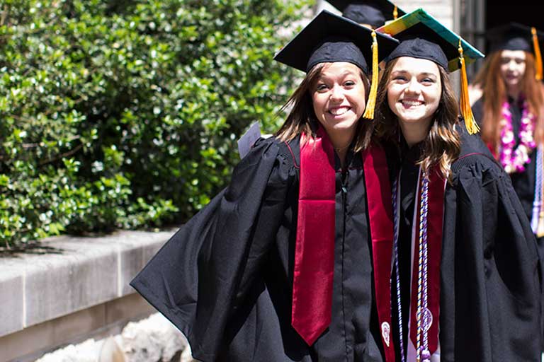 Graduates walking in caps and gowns