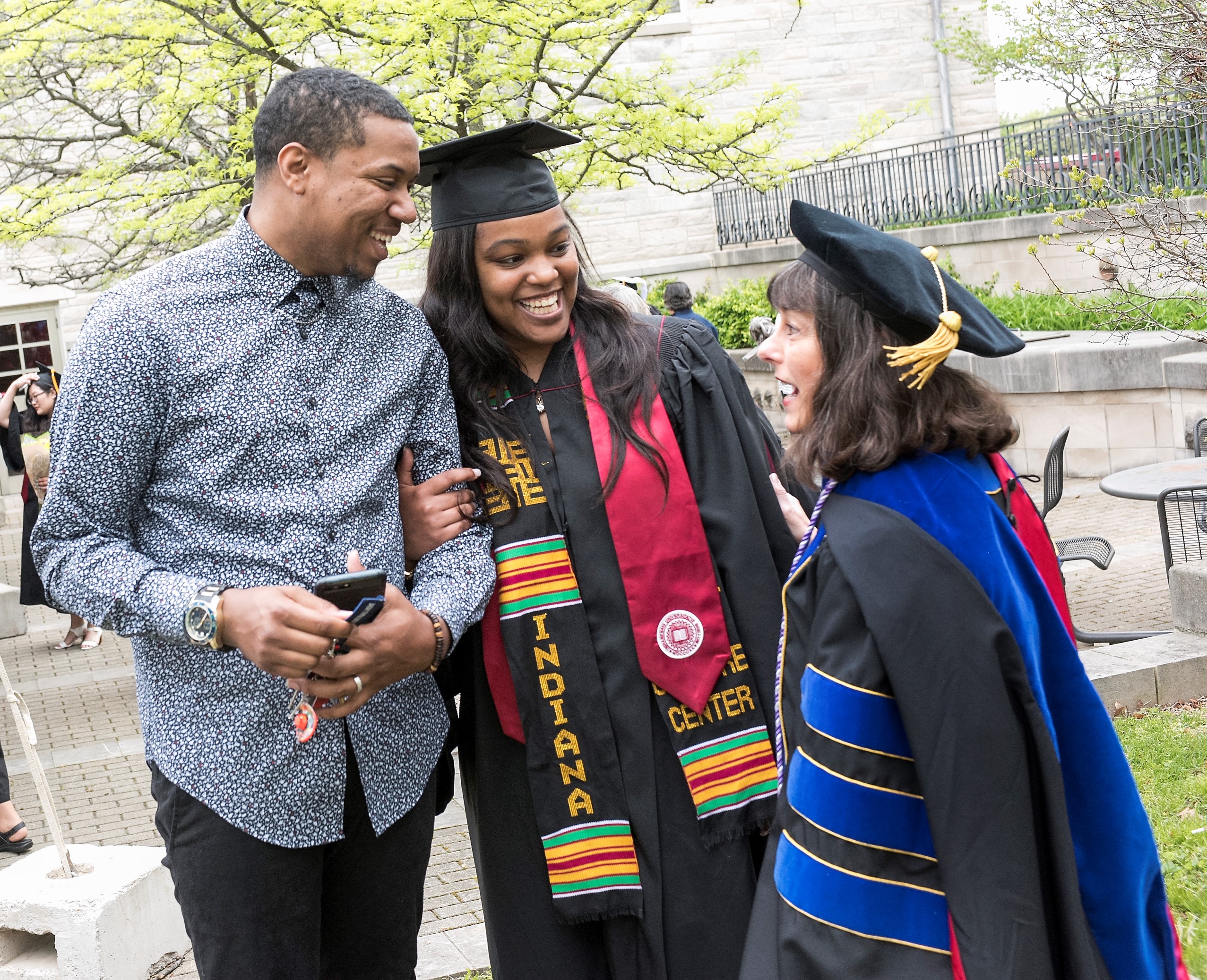 Graduate with family and faculty