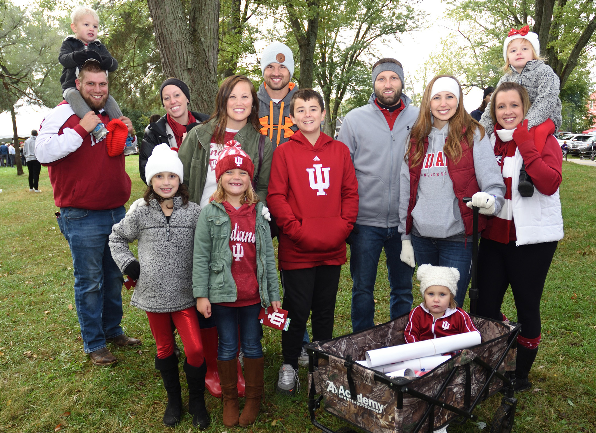 adults and children pose for camera at homecoming