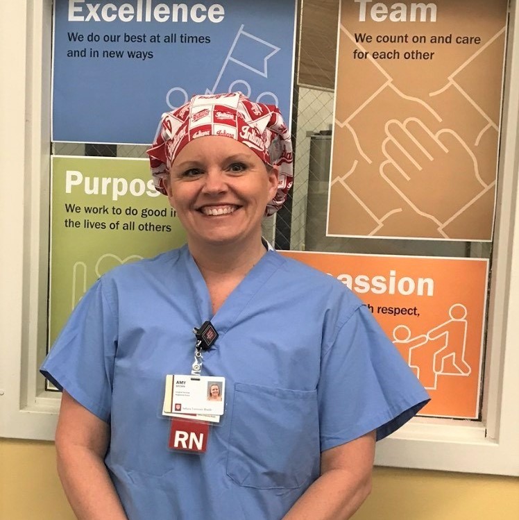 Nurse standing in front of large infographic