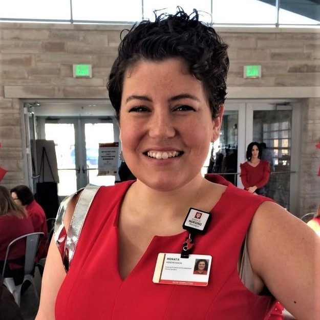 Woman in red smiling at camera