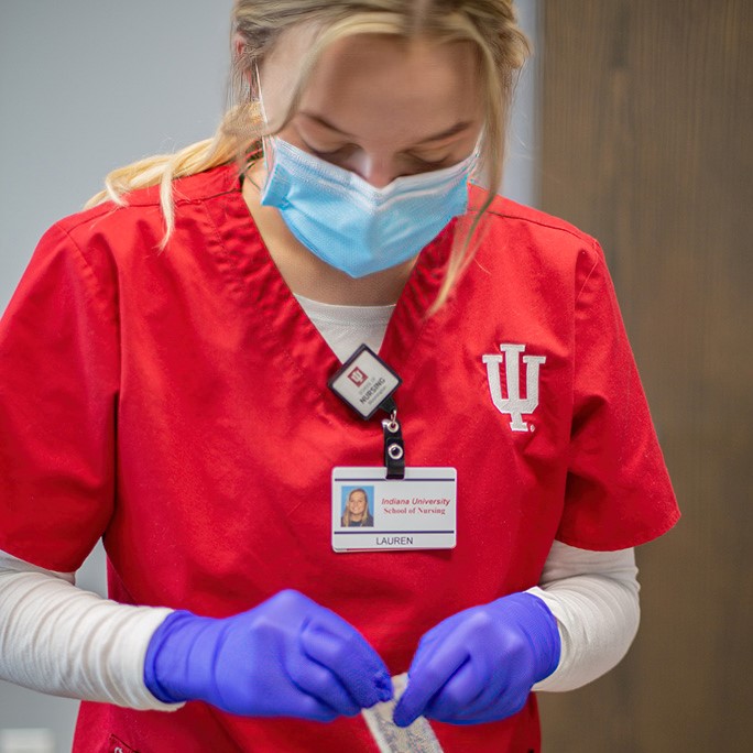 IUSON student in red scrubs