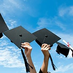 Graduation mortarboards being tossed into the air
