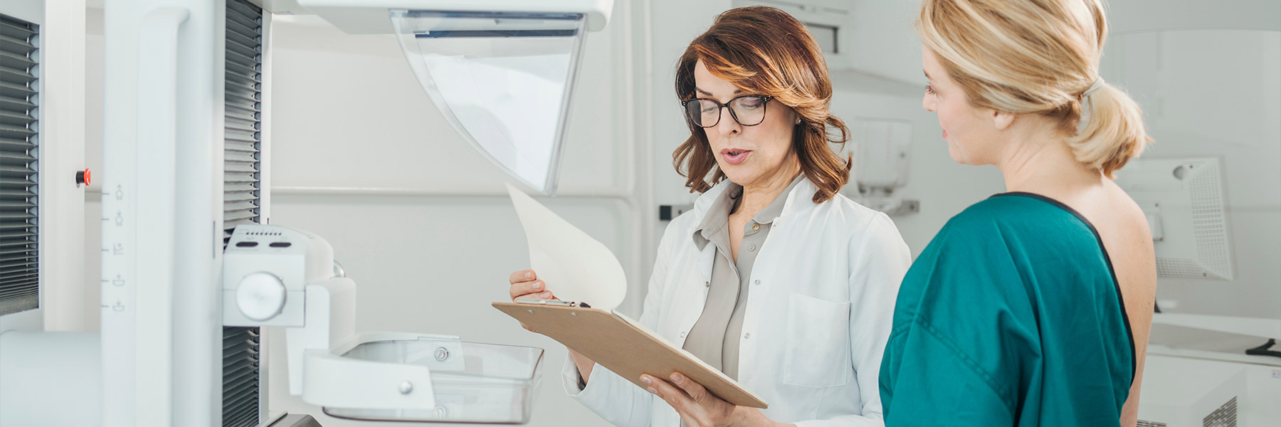 Nurse with a patient getting a mammogram