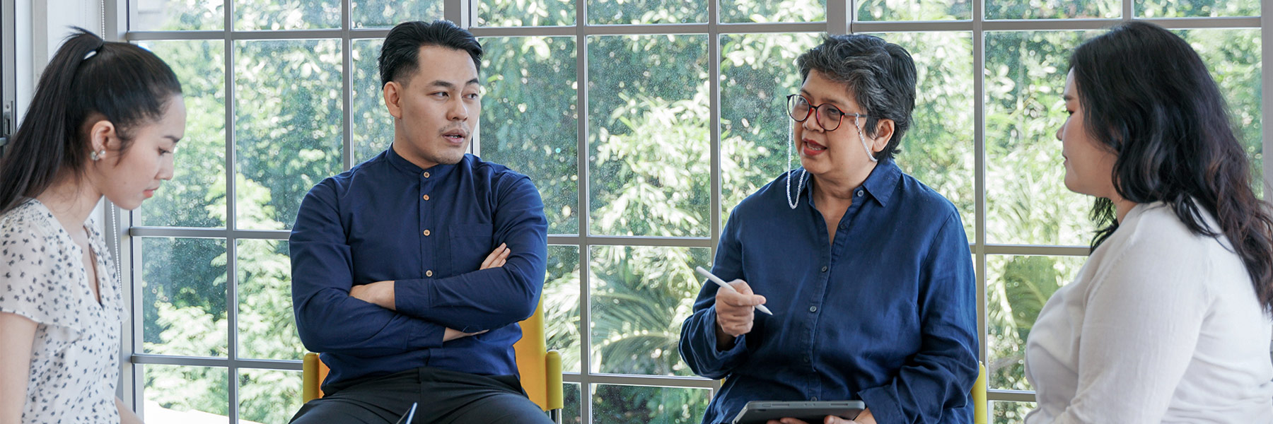 Four people in semi-circle talking